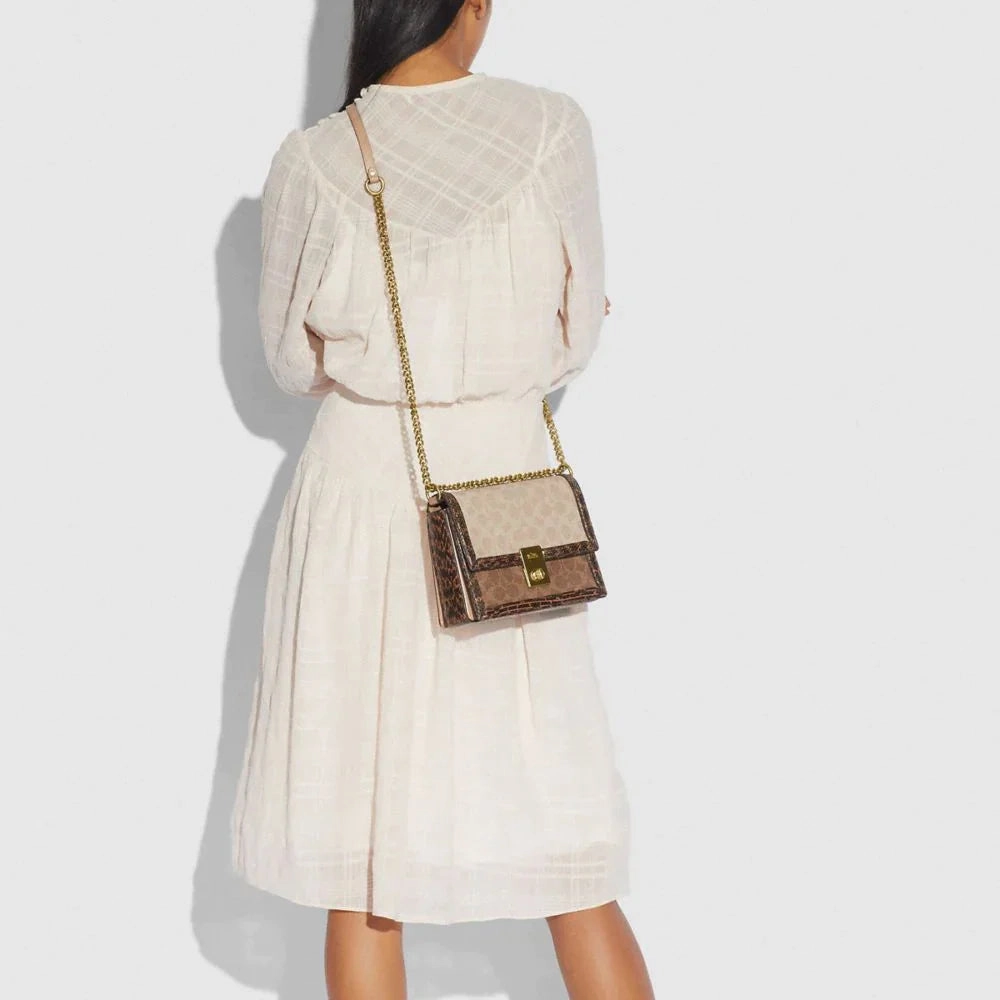 COACH HUTTON SHOULDER BAG IN BLOCKED SIGNATURE CANVAS WITH SNAKESKIN DETAIL